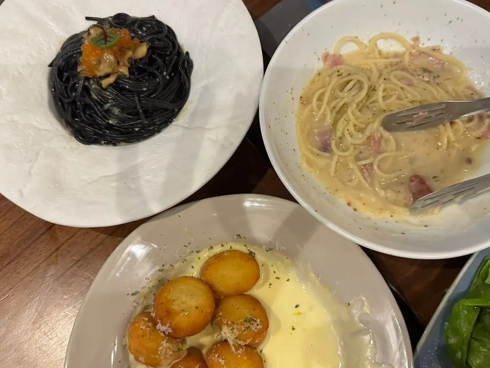 Three pasta and gnocchi dishes on the table
