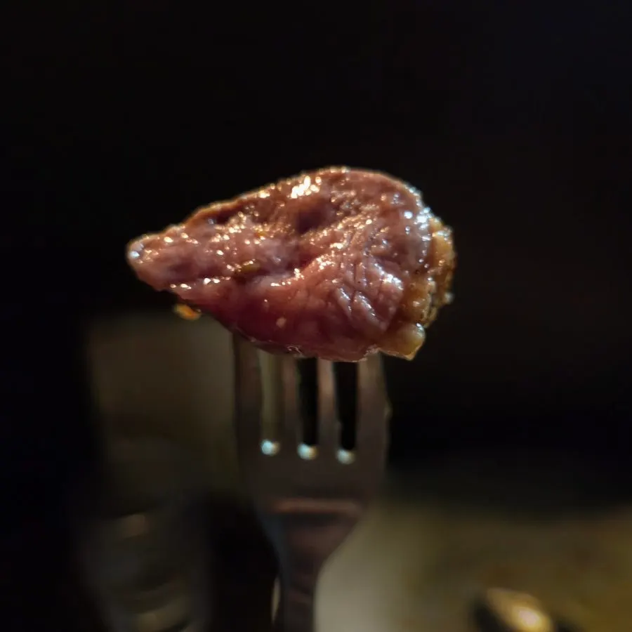 A bite combining duck breast and purée
