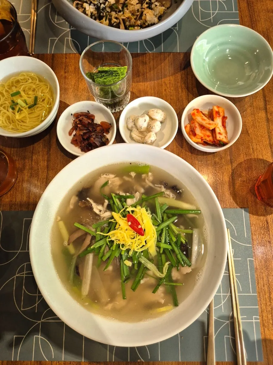 A bowl of mini noodles in clear broth