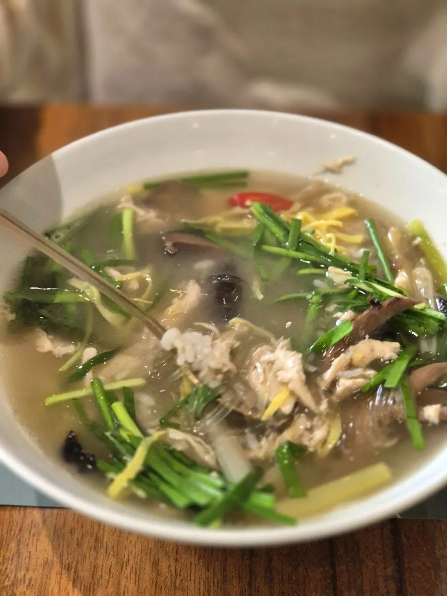 Spooning up the neungi mushroom chicken gomtang