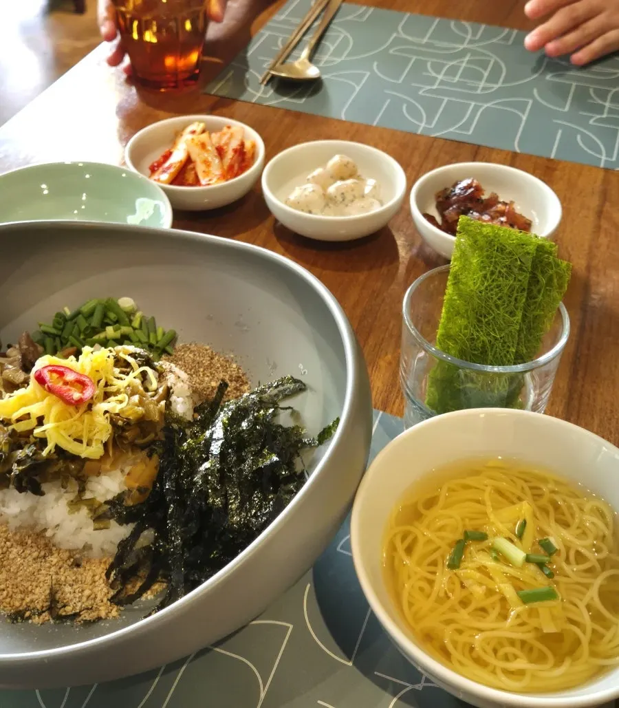 Table with bibimbap, gomtang, and tteokbokki together
