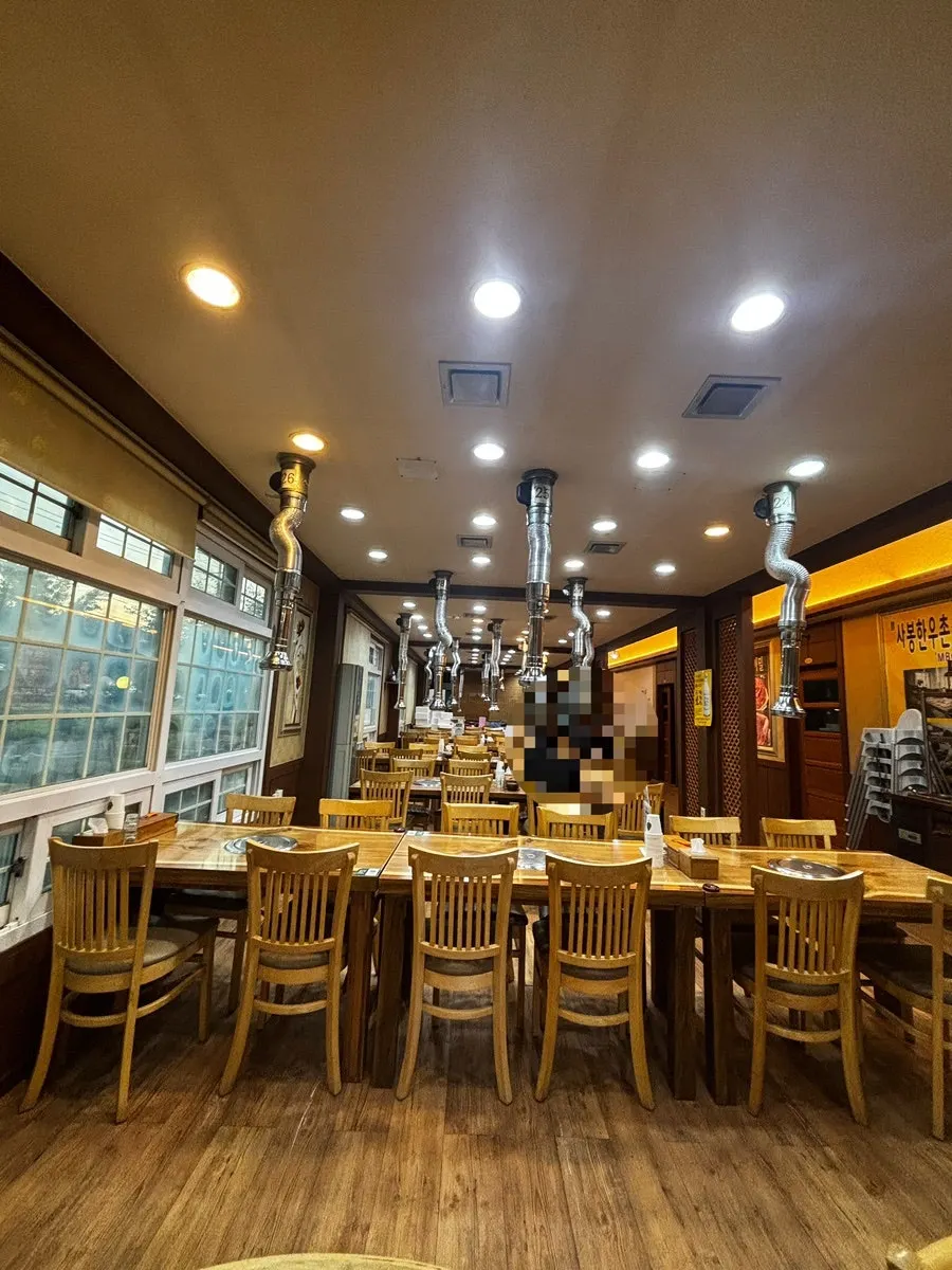 Spacious hall with wooden 4-person tables