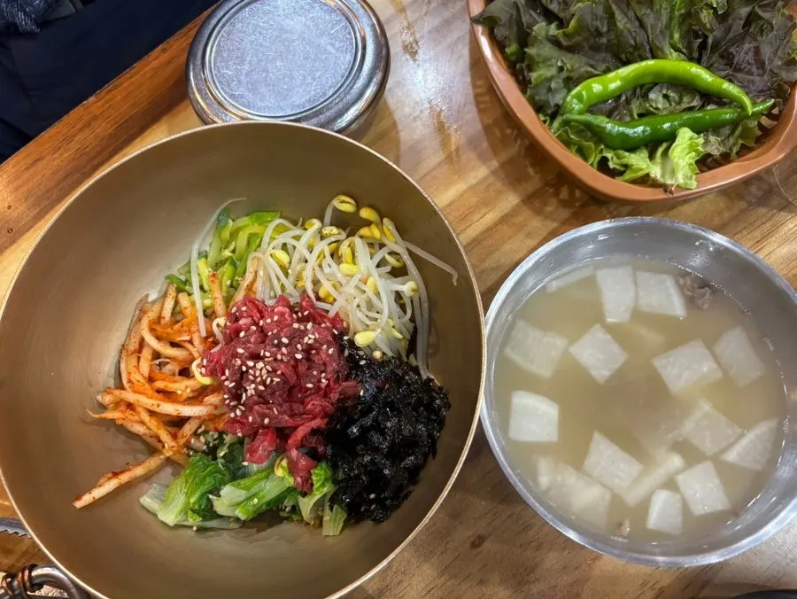 Yukhoe bibimbap topped with bean sprouts and namul