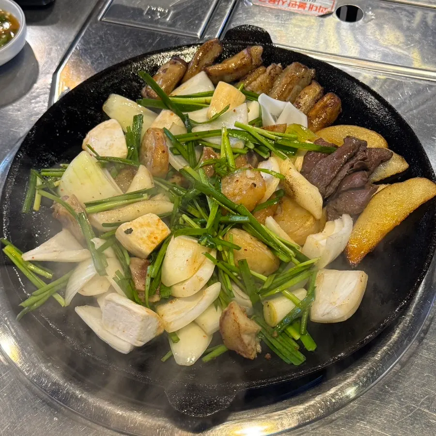 Assorted beef gopchang cooking on the grill