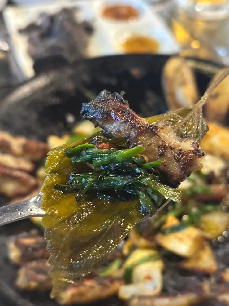A well-grilled piece of gopchang dipped in the special sauce
