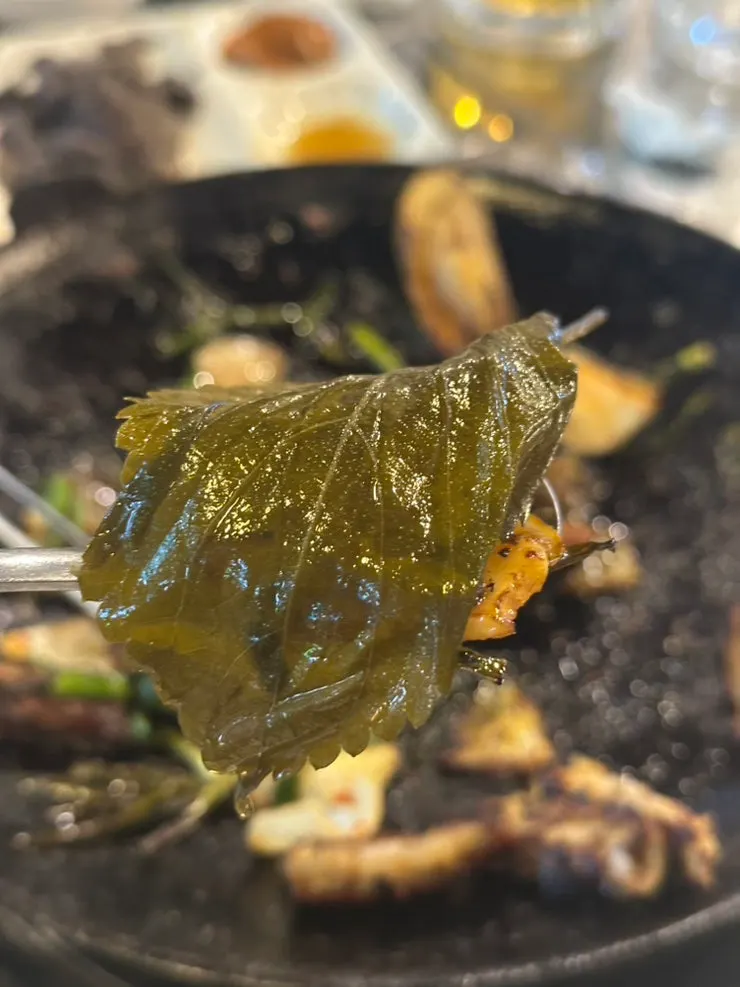 A piece of gopchang paired with chive salad