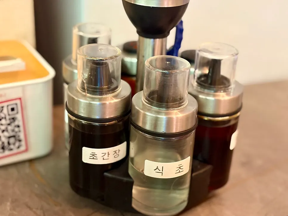 Table setting with vinegar, soy sauce, and chili powder