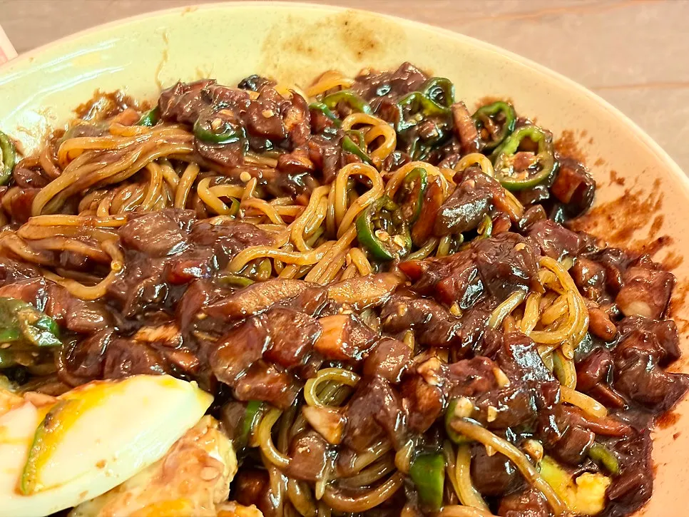 Noodles tossed with the glossy jjajang sauce