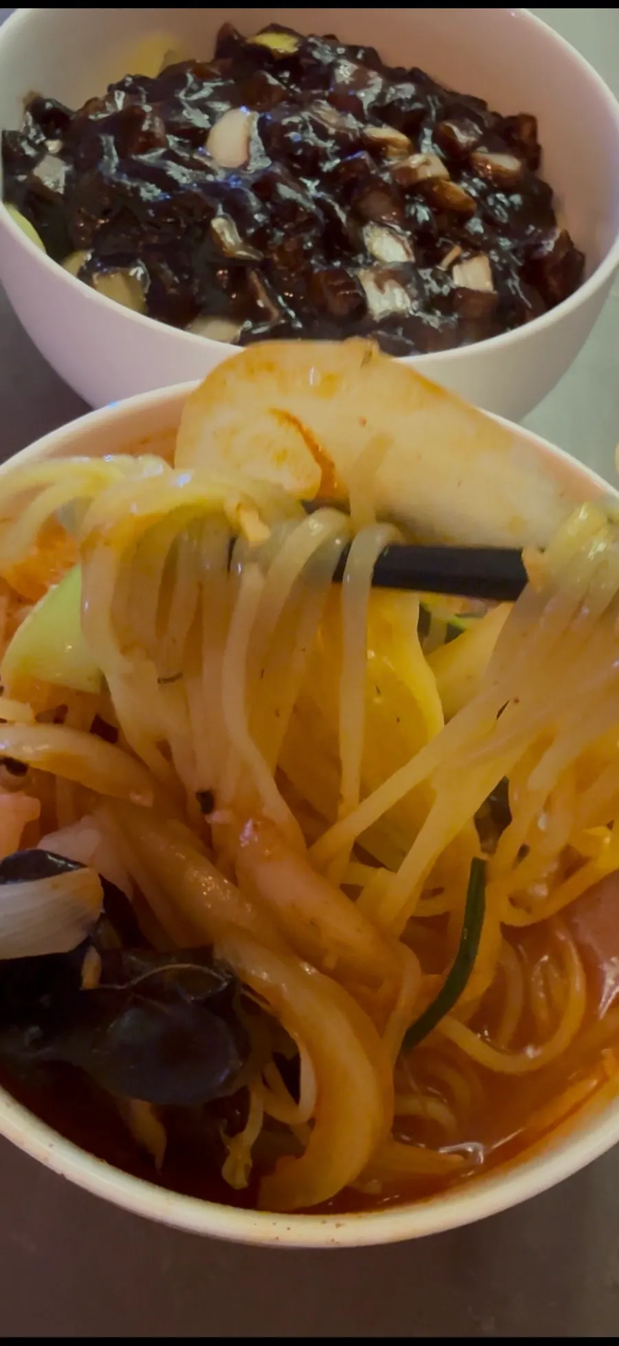 Jjamppong broth with chili oil swirling on top