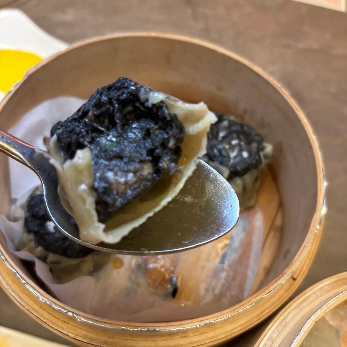 Truffle siu mai dumpling with a squid-ink wrapper
