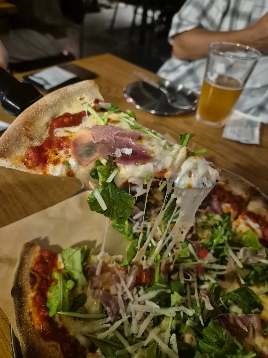 Slice of pizza with long stretchy cheese