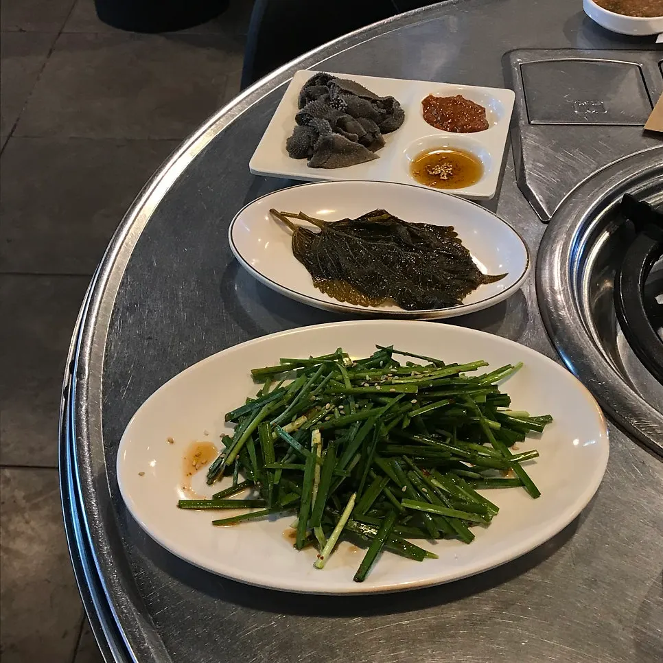 Seasoned chives served alongside the gopchang