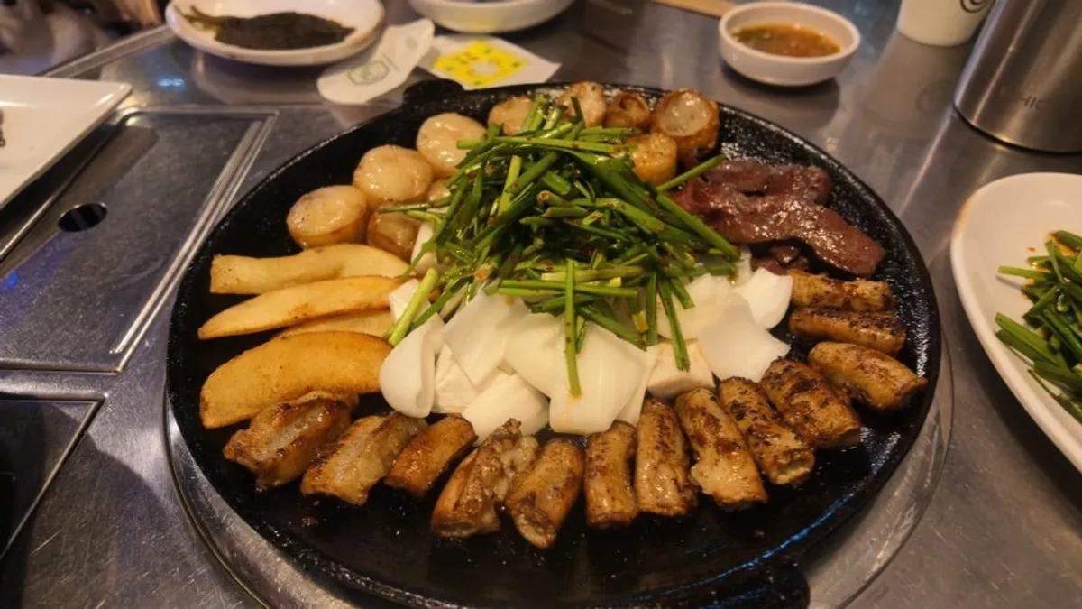 A full serving of assorted gopchang on an iron griddle