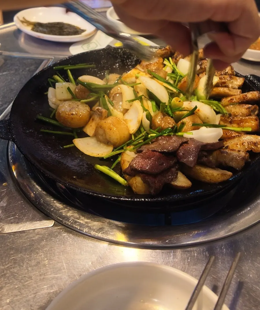 Gopchang and daechang on an iron griddle