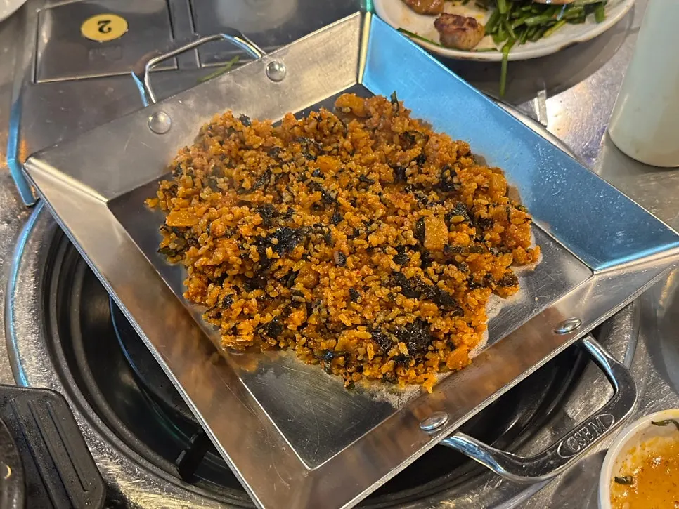 Gopchang and vegetables cooking on the dip-center grill