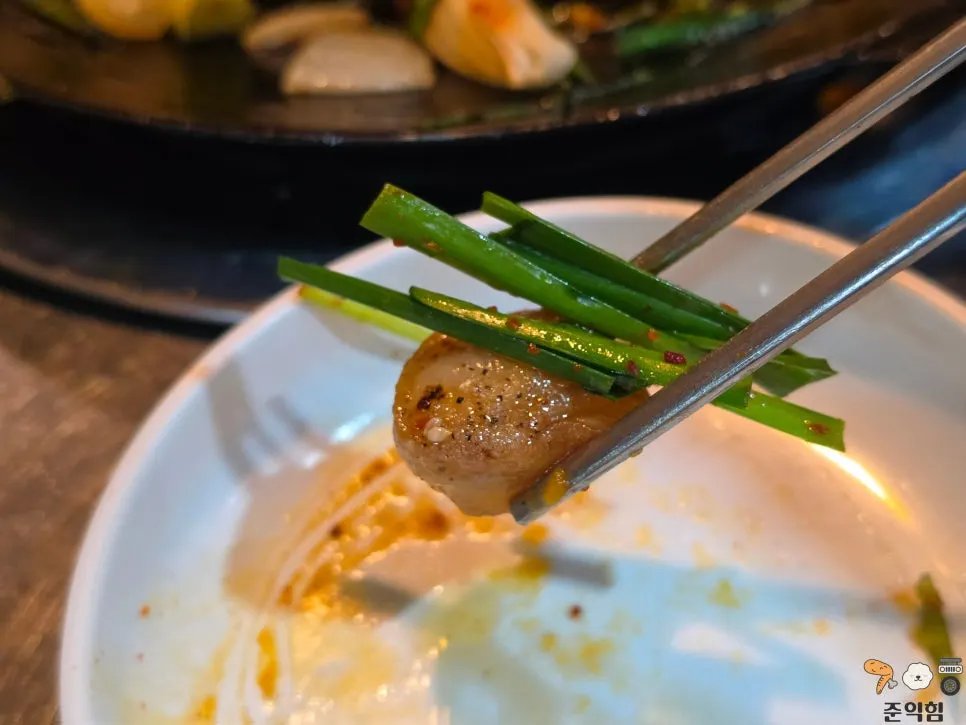 A piece of daechang dipped in sauce