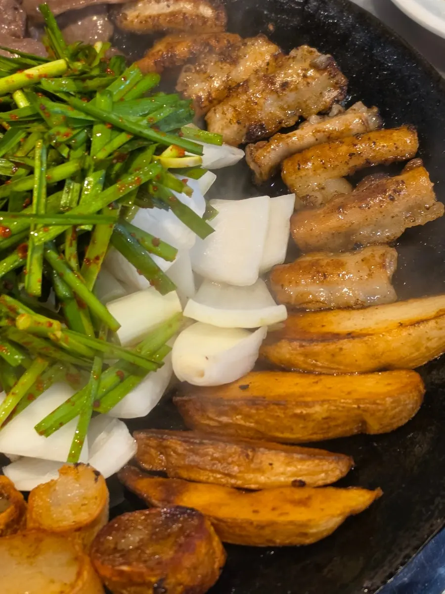 Assorted gopchang cooking on the grill