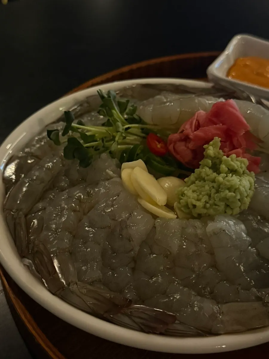 Raw shrimp sashimi served with vinegared chili paste and sriracha mayo