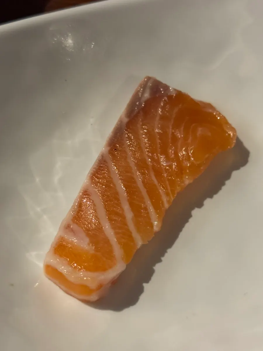 Salmon dipped in soy sauce and wasabi