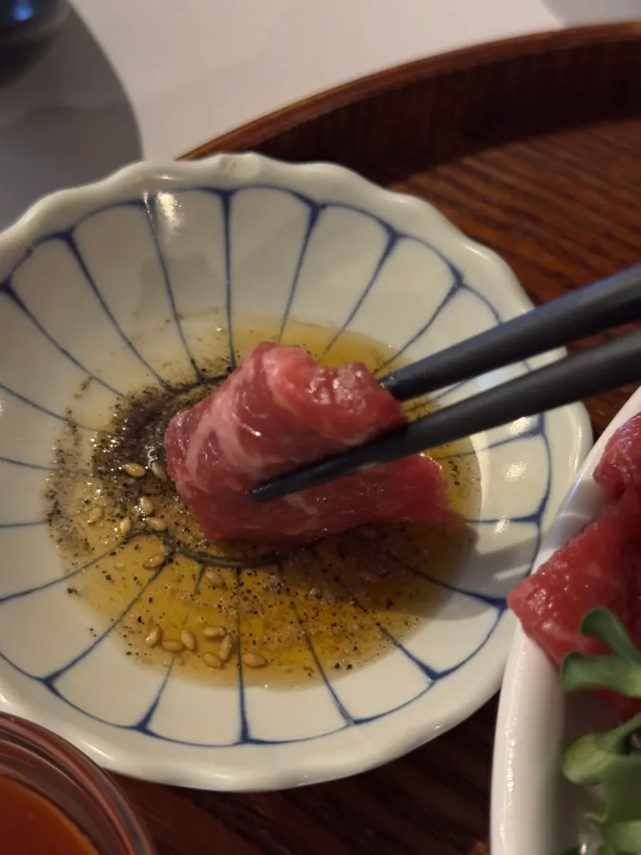 Beef sashimi dipped in salt oil sauce