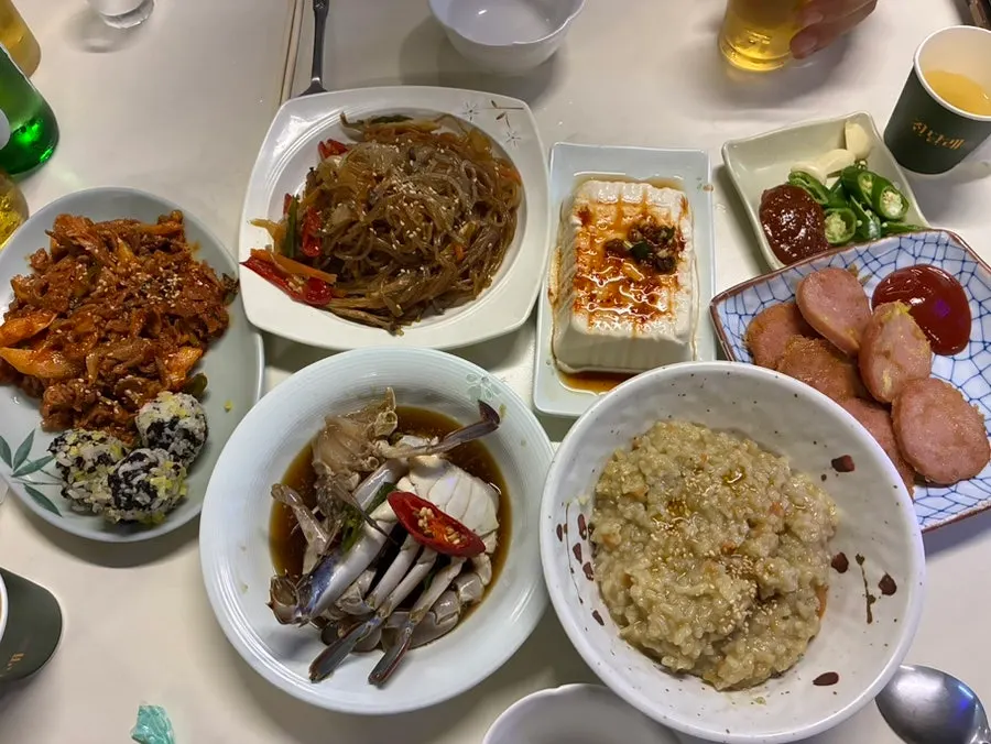 Pink sausage, japchae, and other side dishes
