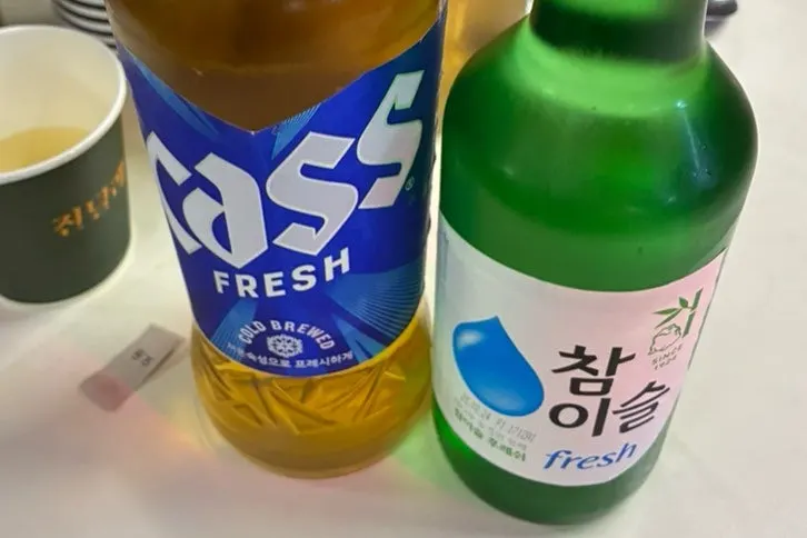Soju and beer served alongside the food