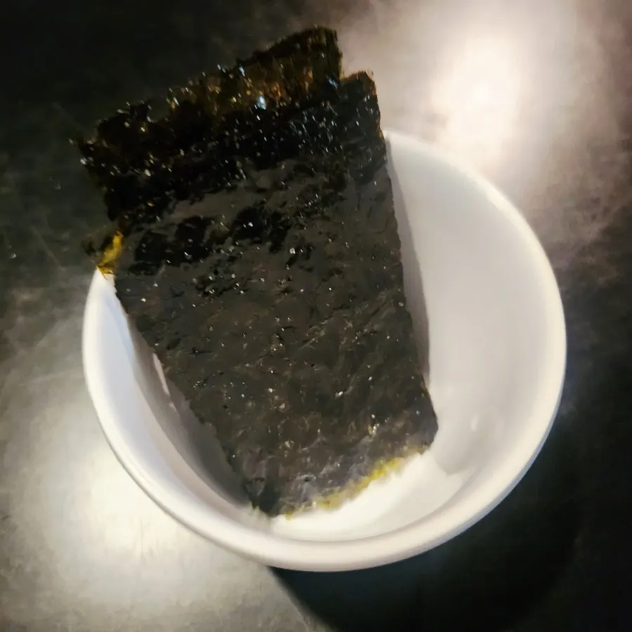 Seasoned gim served alongside the raw shrimp sashimi