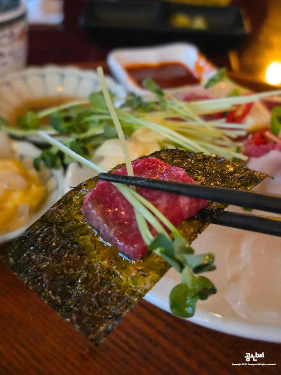 Yukhoe wrapped in seaweed with radish sprouts