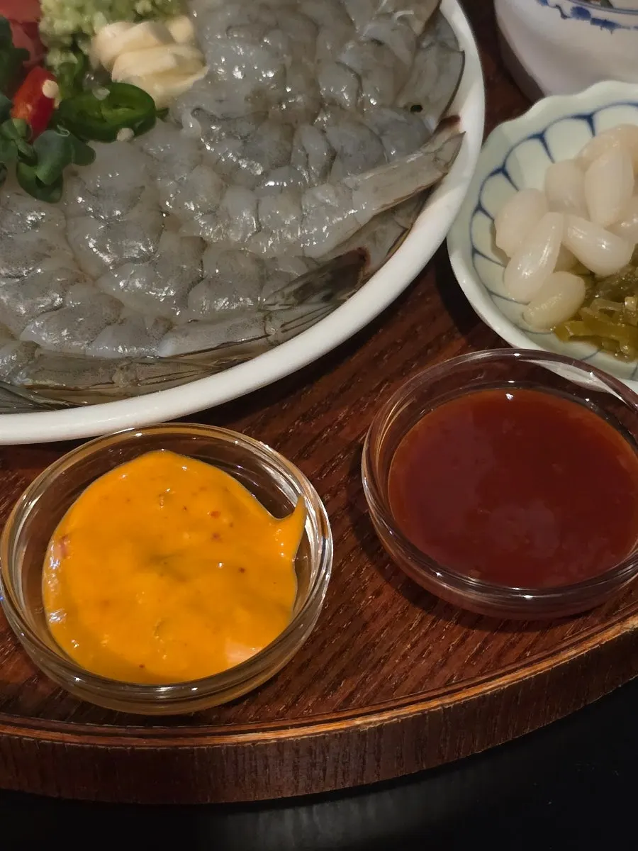 Sauces served alongside the raw shrimp sashimi, including chojang