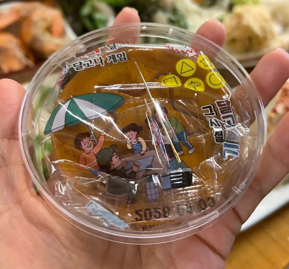 Dalgona game with a bottle of soju prize