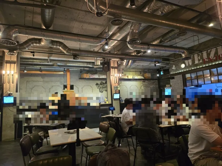 Overview of the pub-style hall with high ceilings on the basement level