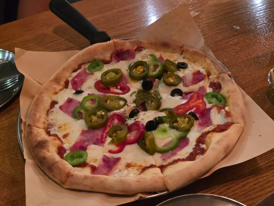 A whole bacon jalapeño pizza cut into 8 slices