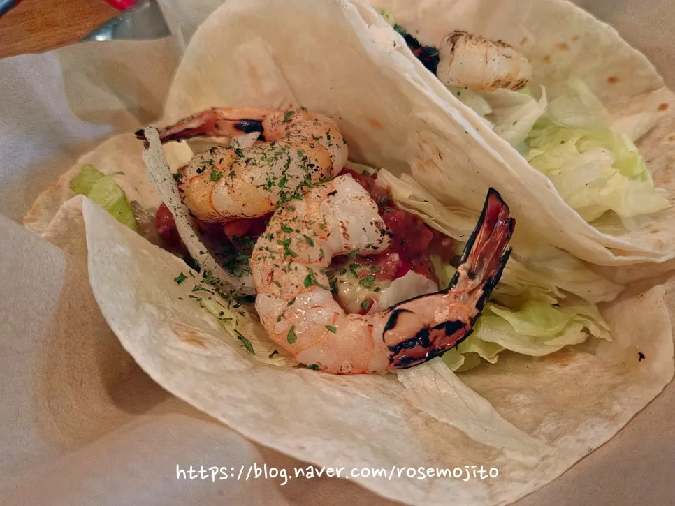 Close-up of taco with shrimp and lettuce