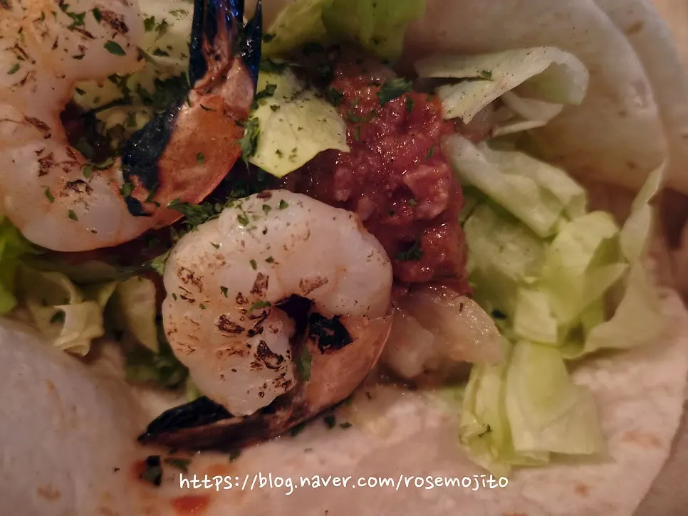 Shrimp taco topped with tomato salsa