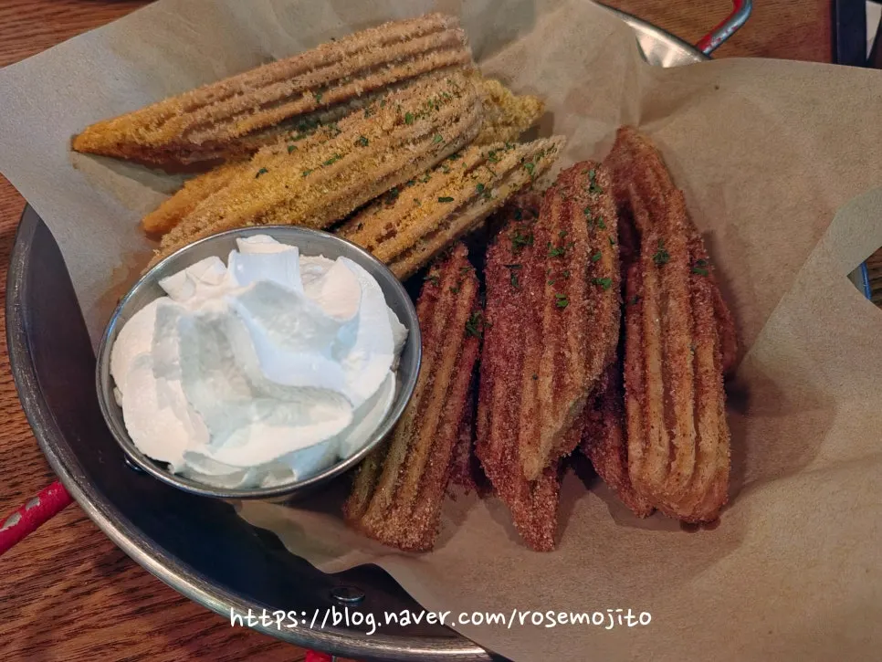 Plate of churros served with whipped cream