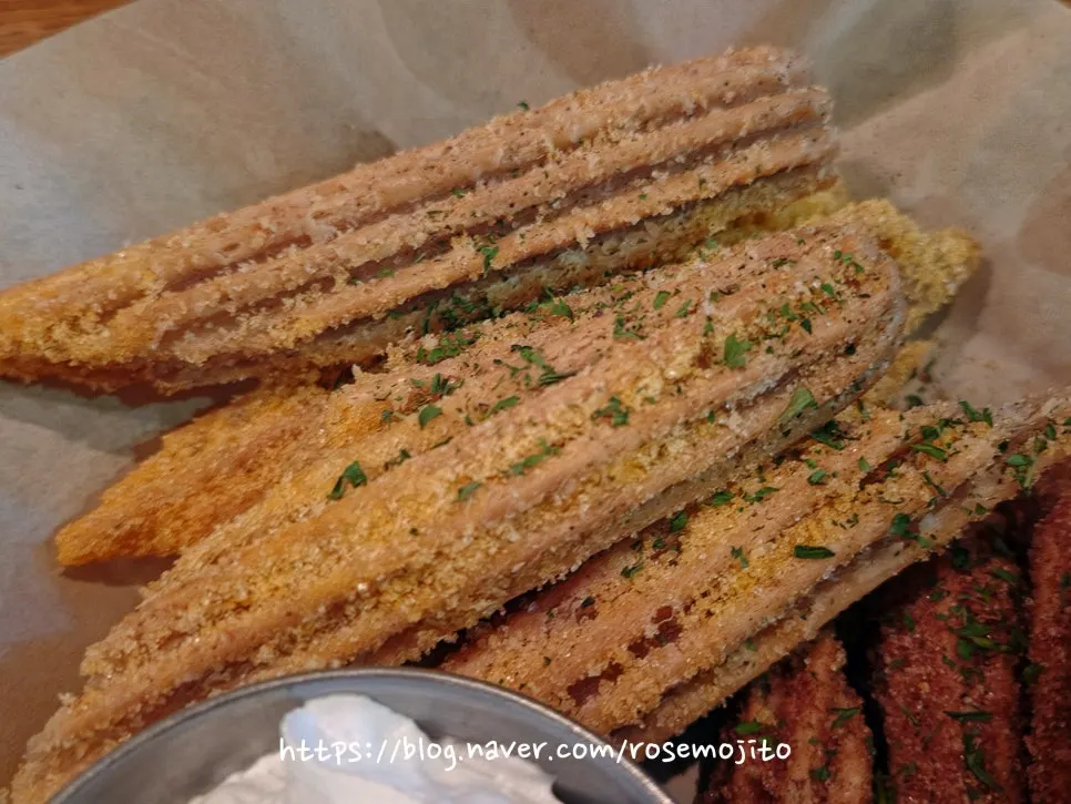 Whipped cream served alongside churros