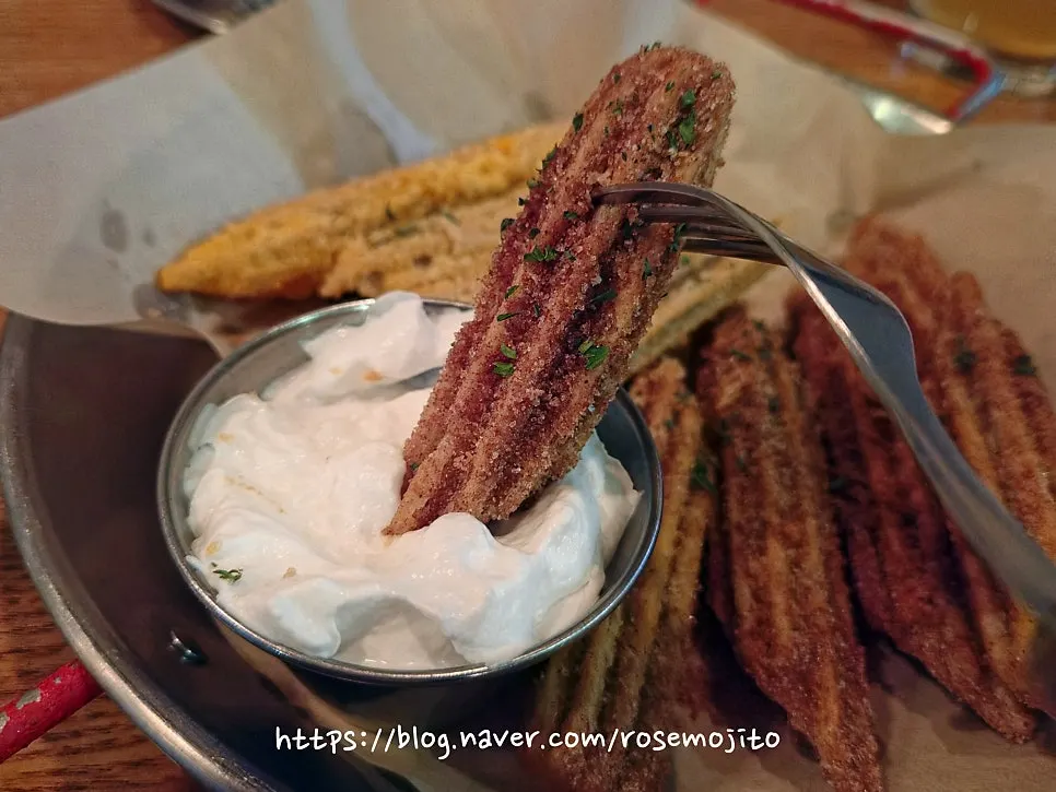 Churros dipped into whipped cream