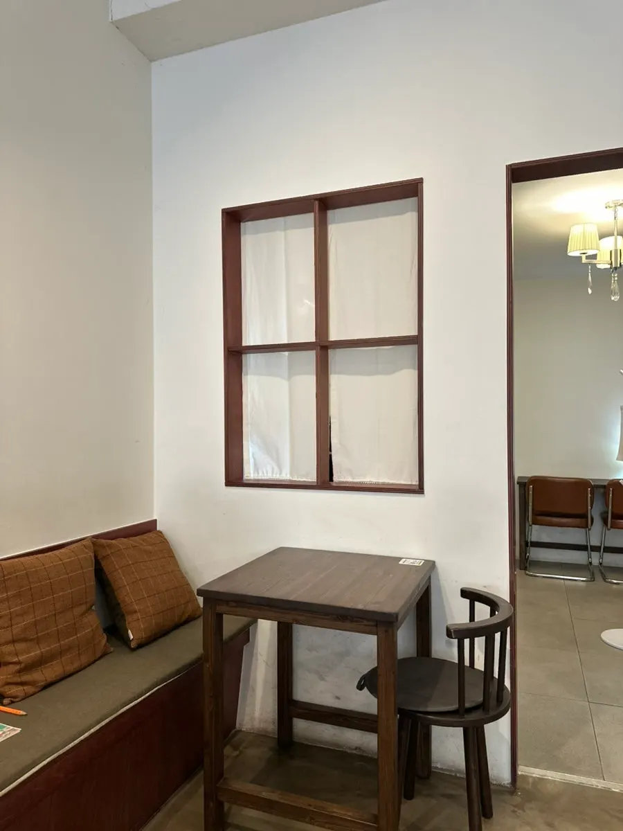 Warmly lit wood-tone café seating inside