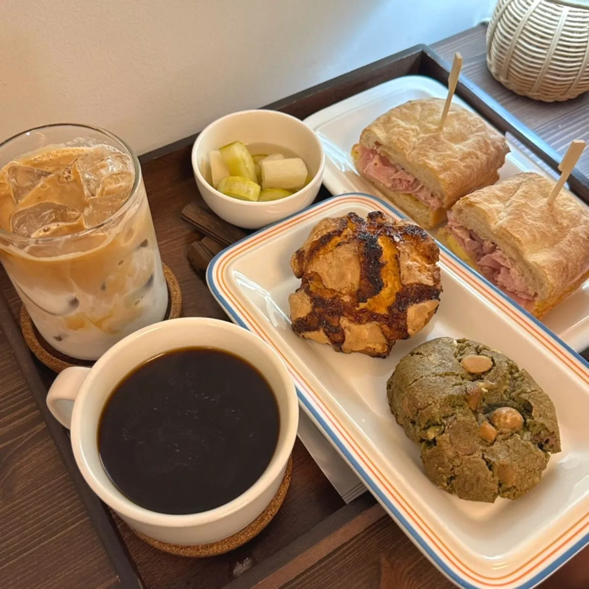 Table setting with jambon-beurre sandwich set, caffè latte, and desserts
