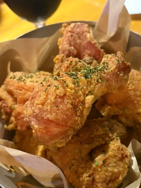 Chicken piled high in a basket with two sauces