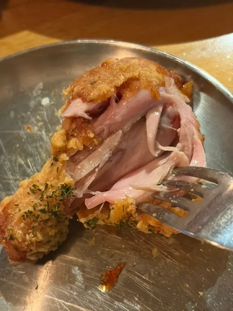 Close-up of a crispy piece of fried chicken