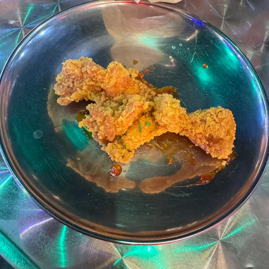 A piece of spicy red-sauced chicken