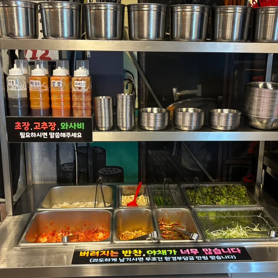 Containers of side dishes at the self-serve bar