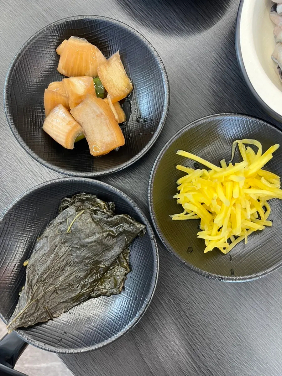Pickled perilla leaves, pickled onions, and ginger side dishes