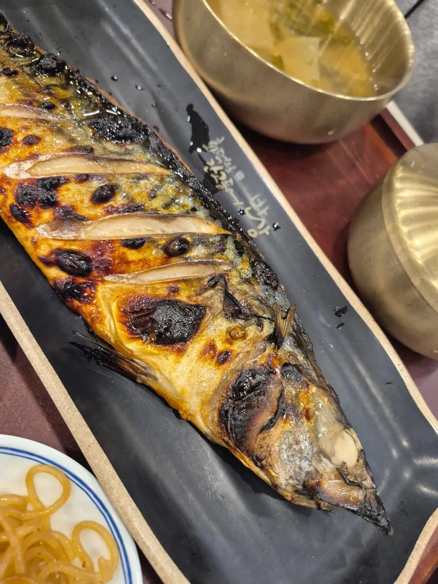 Grilled mackerel flesh flaked apart