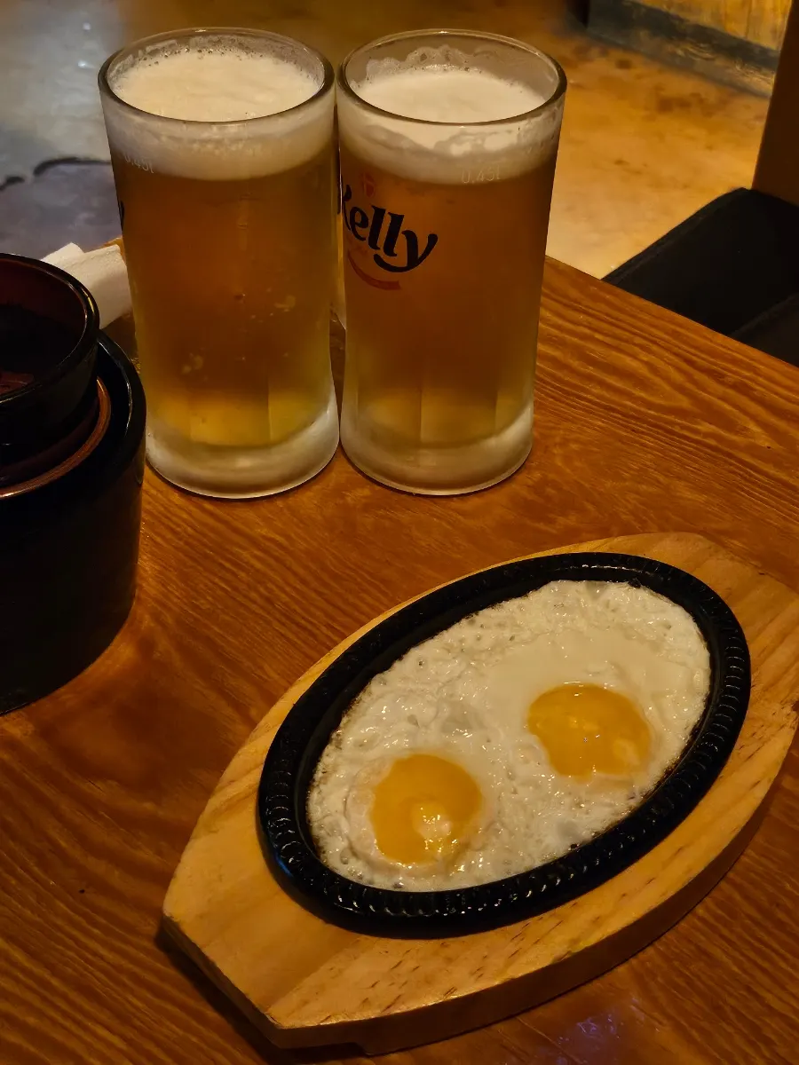 Soft-set fried egg complimentary snack on a hot plate