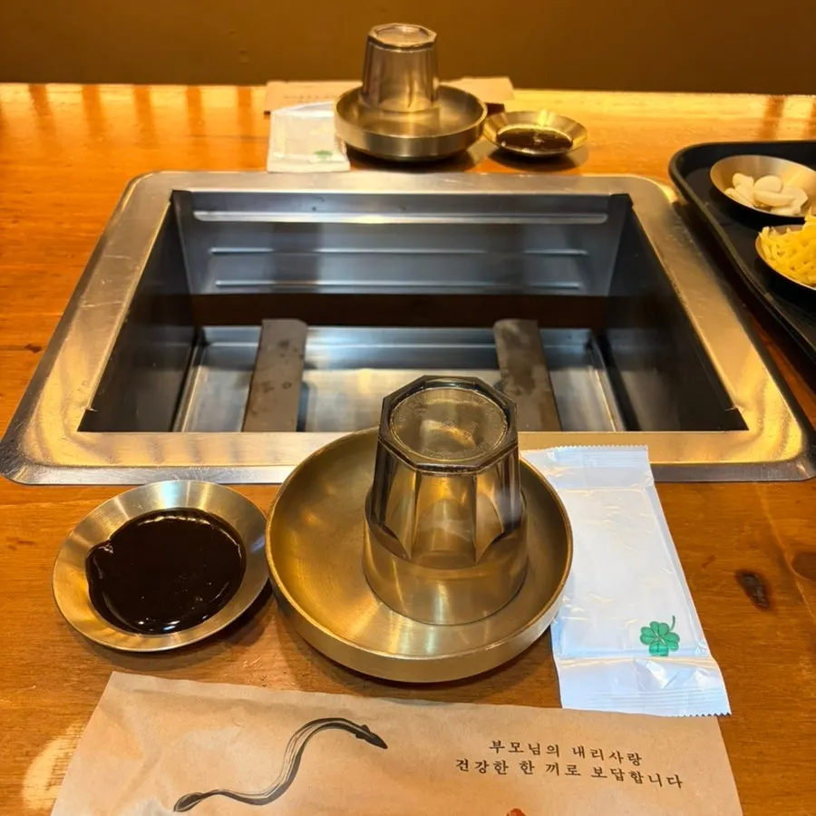 Reserved table set with spoons and side plates via Naver Reservation