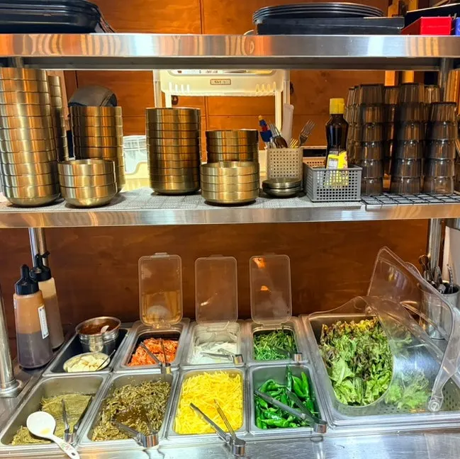 Side dishes and gim jaban set out at the self-serve bar