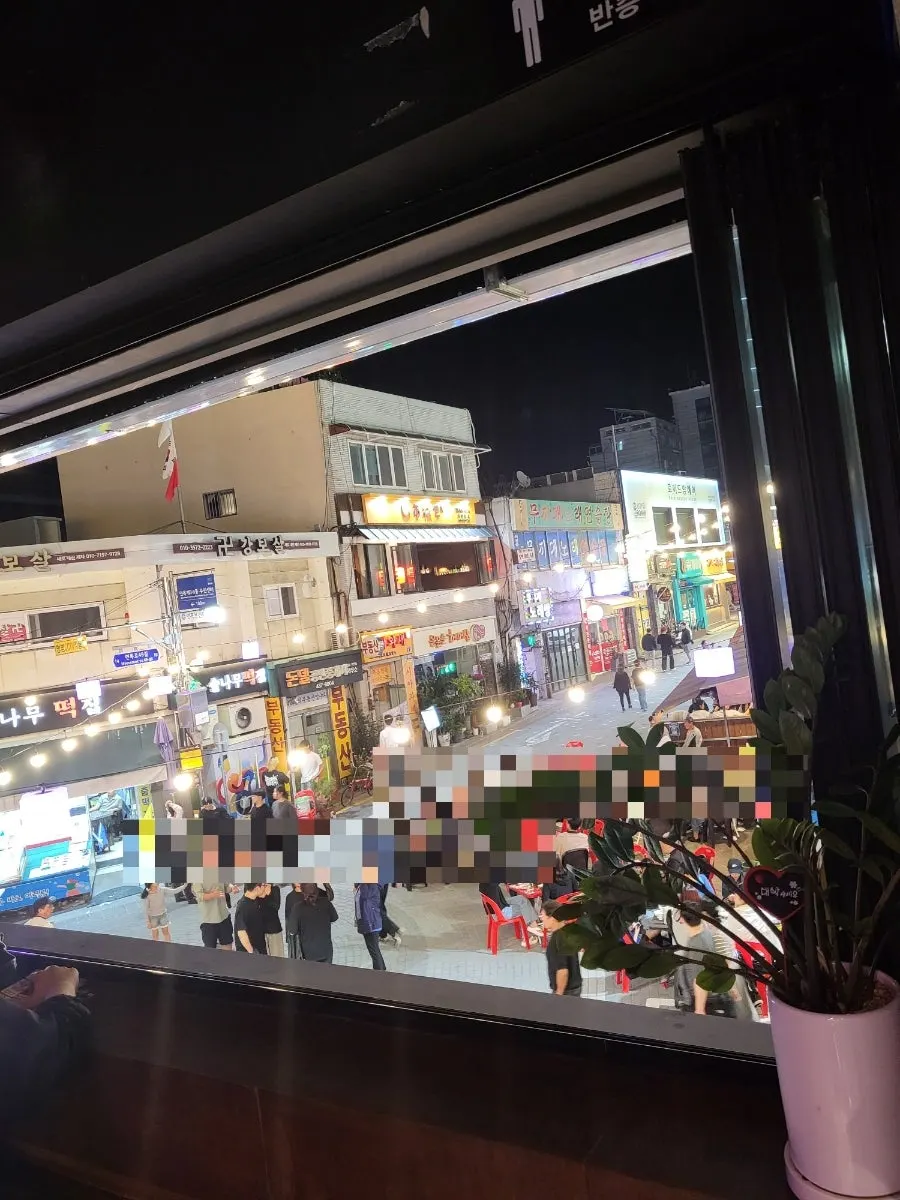 Window-side seating at Sungan Pocha with the large window wide open