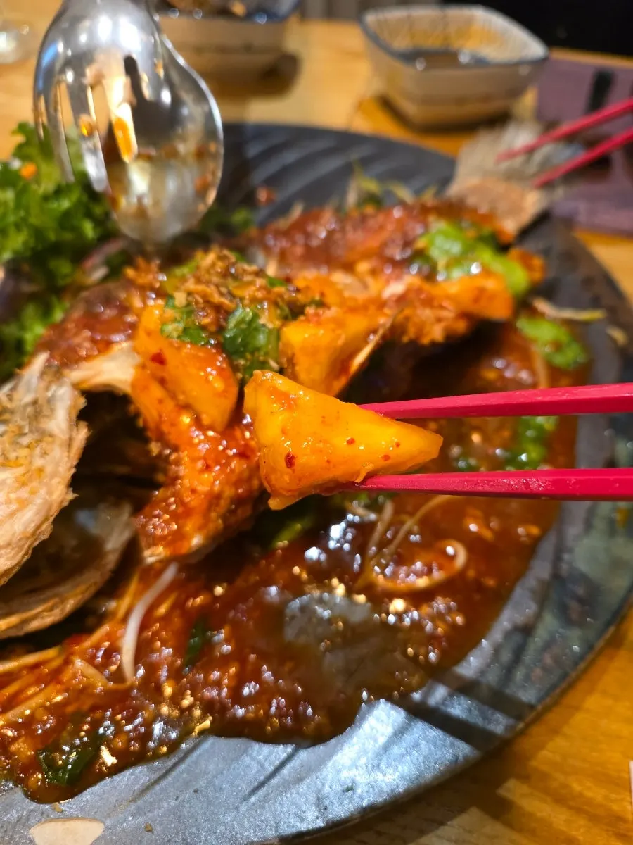 Chili-topped sea bass served with a side salad